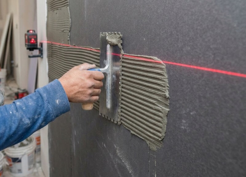 traight directional troweling of thinset mortar using a laser level.
